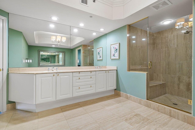 bathroom with a tray ceiling, vanity, walk in shower, and tile patterned flooring