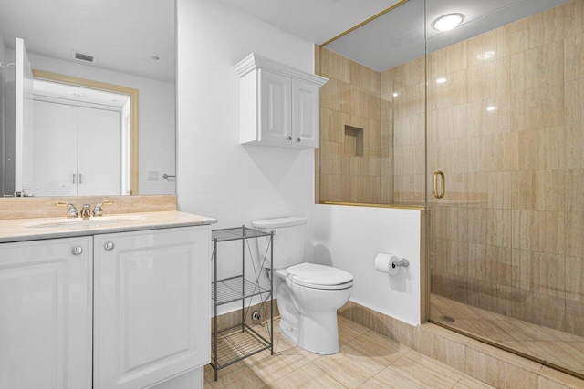 bathroom with an enclosed shower, vanity, toilet, and tile patterned floors