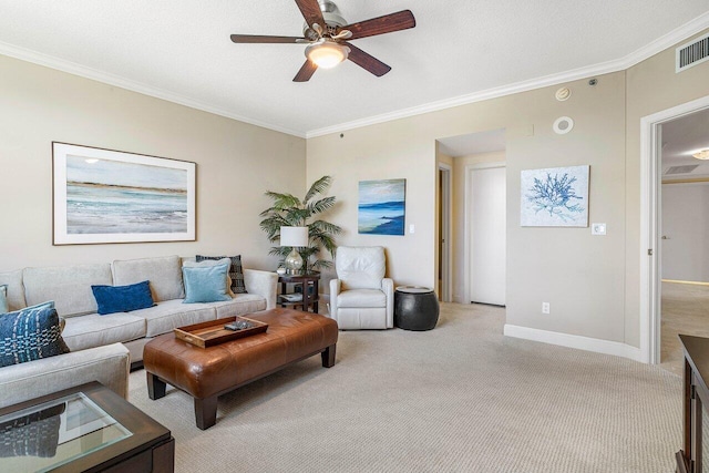 carpeted living room featuring ceiling fan and ornamental molding