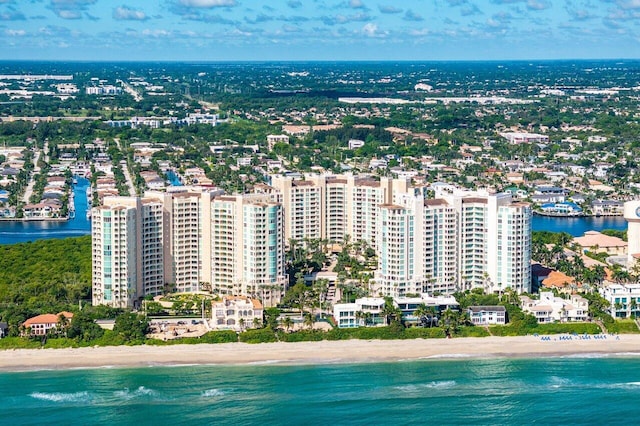 birds eye view of property with a water view and a beach view