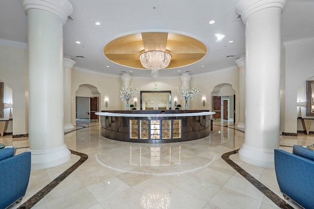 reception area featuring a chandelier and ornate columns