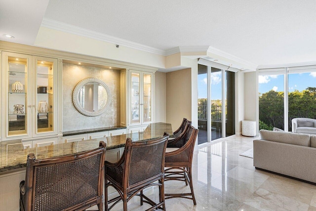 dining space featuring crown molding and a textured ceiling