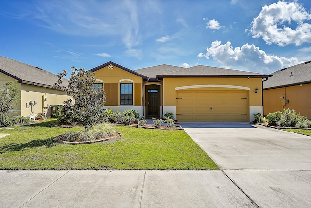 view of front facade featuring a front yard and a garage