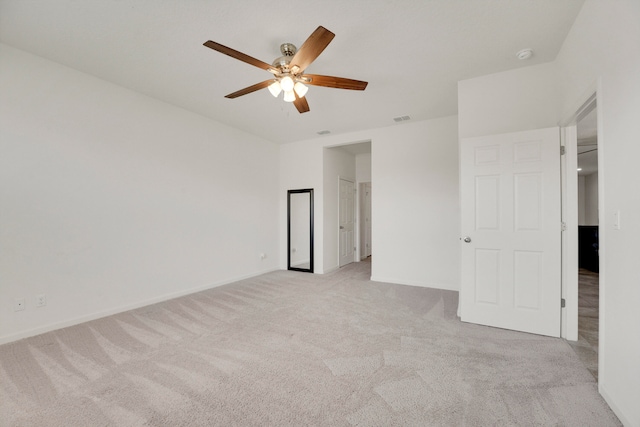 unfurnished bedroom with ceiling fan and light colored carpet