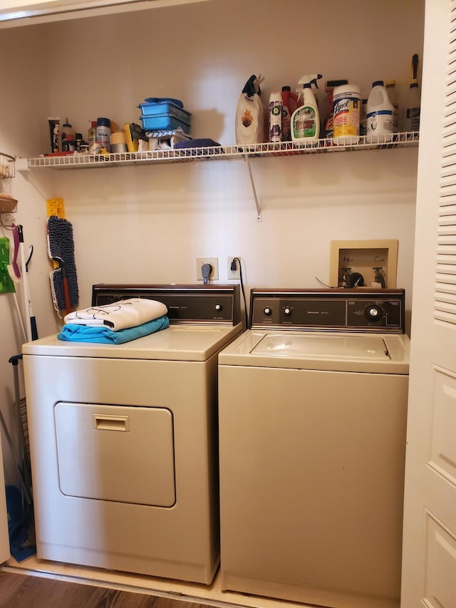 laundry area featuring wood-type flooring and washer and clothes dryer