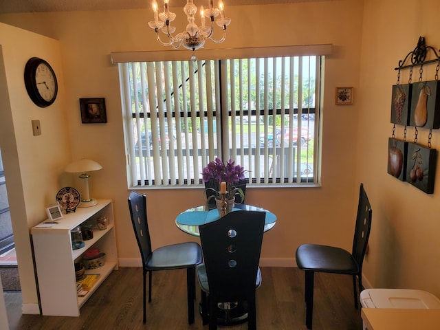 dining room featuring a notable chandelier and dark wood-type flooring