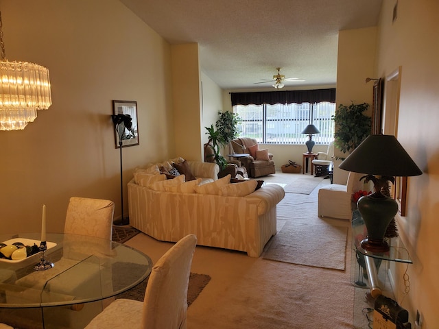 living room with light carpet, ceiling fan, and a textured ceiling