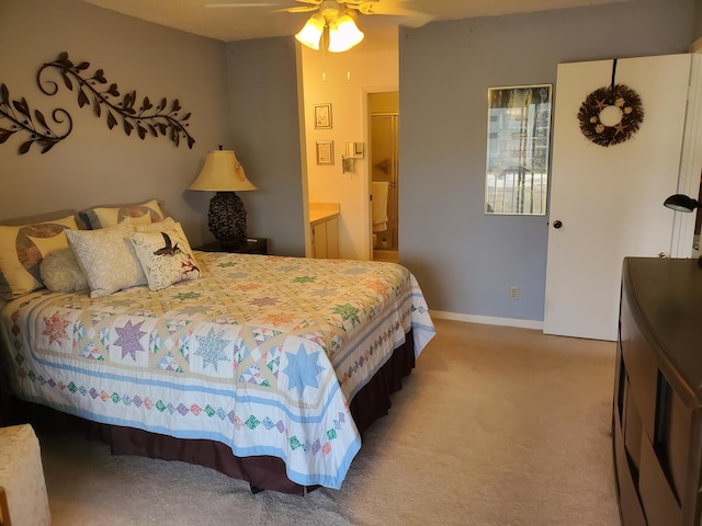 carpeted bedroom with ceiling fan and connected bathroom