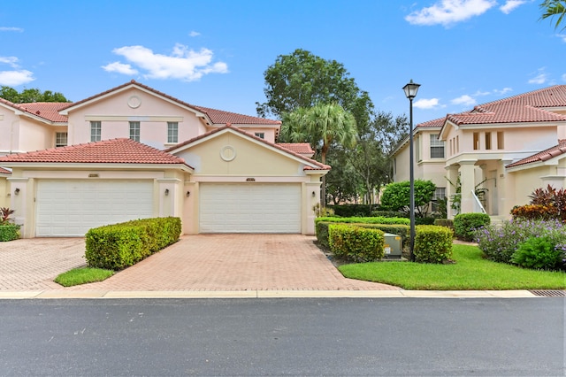 mediterranean / spanish-style house with a garage