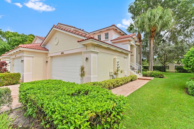 view of side of property featuring a garage and a lawn