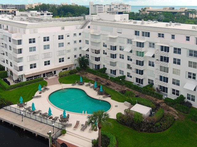 view of swimming pool featuring a yard and a patio