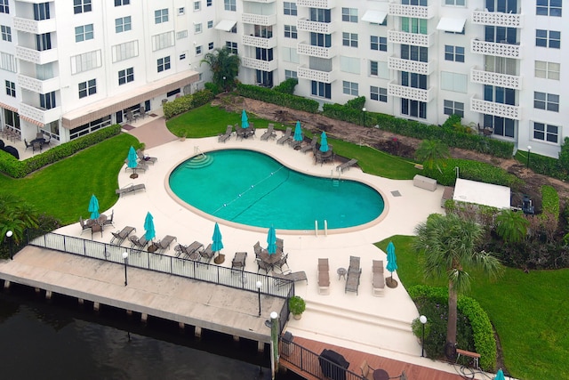 view of swimming pool featuring a patio and a lawn