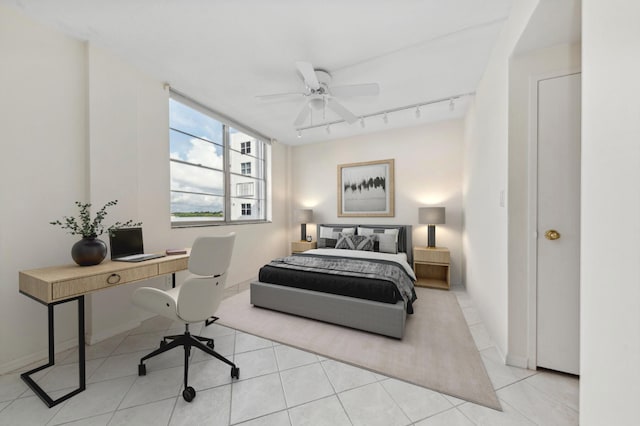 tiled bedroom with ceiling fan and track lighting