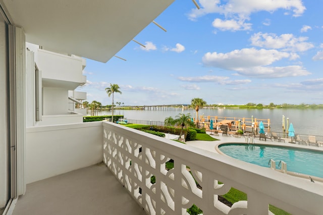 balcony with a patio area and a water view