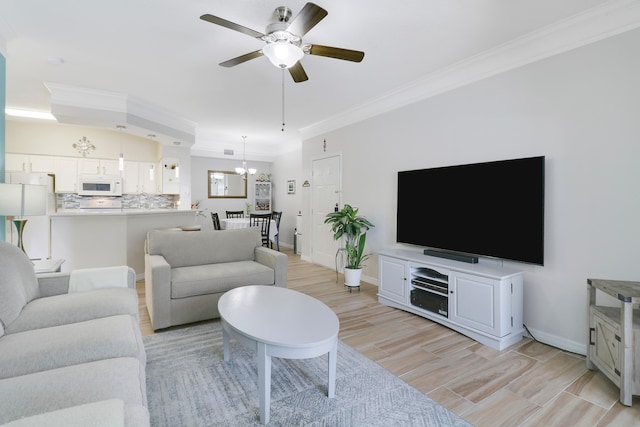 living room featuring ceiling fan with notable chandelier, light hardwood / wood-style floors, and crown molding