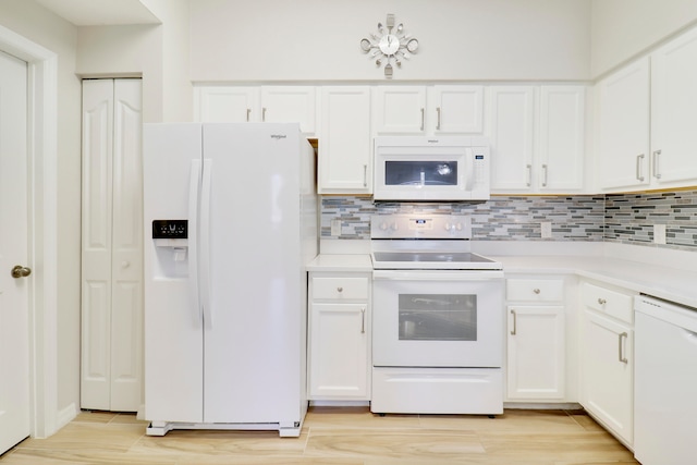 kitchen with decorative backsplash, white appliances, light hardwood / wood-style floors, and white cabinetry