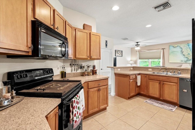 kitchen featuring a textured ceiling, sink, black appliances, light tile patterned floors, and ceiling fan