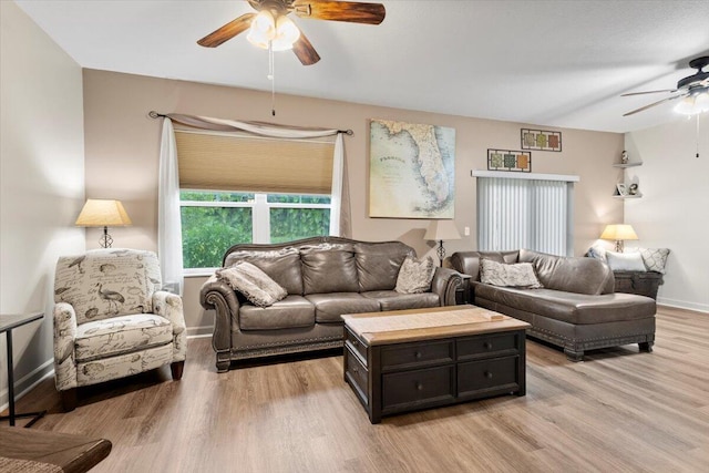 living room with light wood-type flooring and ceiling fan