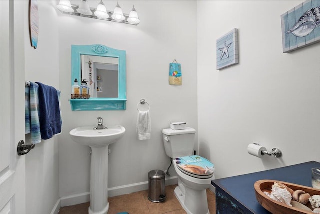 bathroom with sink, tile patterned flooring, and toilet