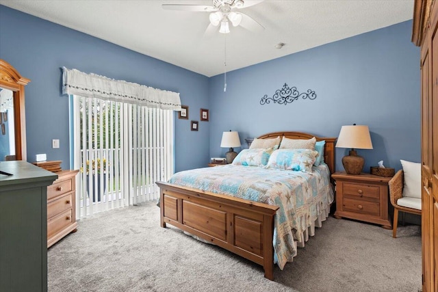 bedroom with light carpet, ceiling fan, and access to exterior