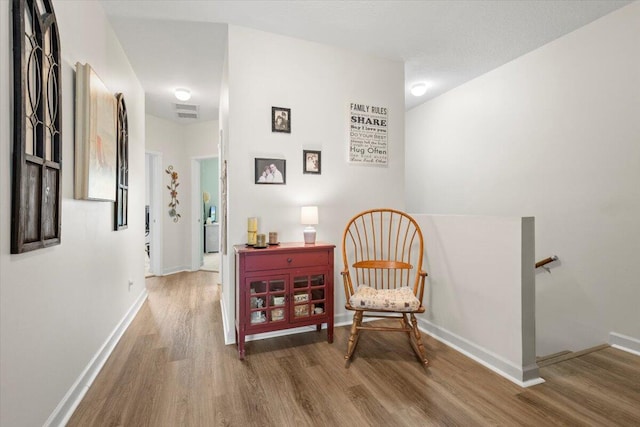 sitting room featuring wood-type flooring