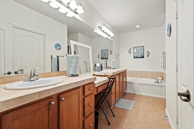 bathroom featuring vanity, tile patterned flooring, and a washtub