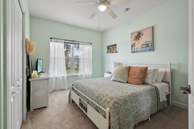 carpeted bedroom with a closet and ceiling fan