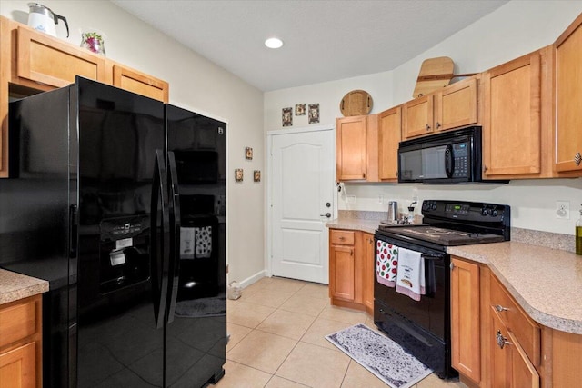 kitchen with black appliances and light tile patterned floors