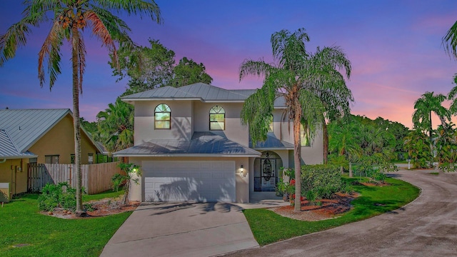 view of front of home with a lawn and a garage