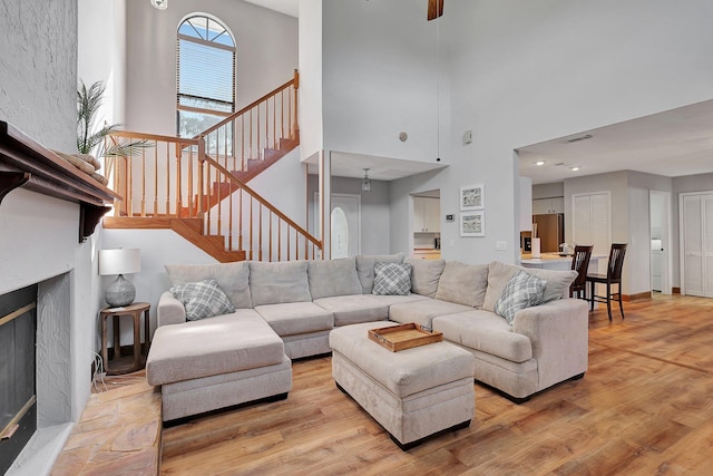 living room with a high ceiling and light hardwood / wood-style flooring