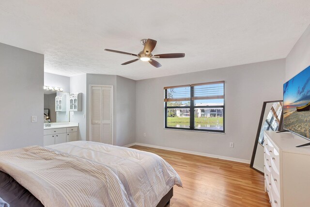 kitchen featuring light hardwood / wood-style floors, white cabinetry, stainless steel electric range oven, and sink