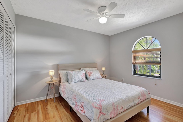 bedroom featuring ceiling fan, a closet, a textured ceiling, and hardwood / wood-style flooring