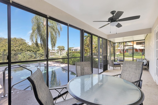 sunroom featuring ceiling fan