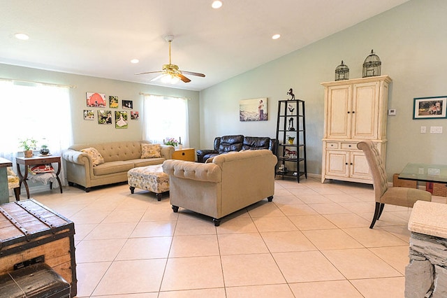 living room featuring ceiling fan, light tile patterned floors, and vaulted ceiling