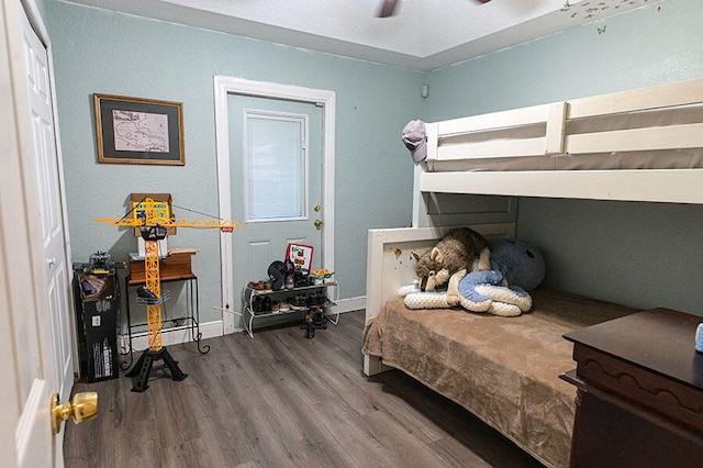 bedroom featuring ceiling fan, a closet, and hardwood / wood-style floors