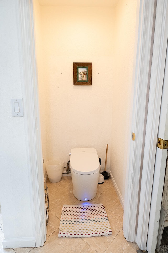 bathroom with tile patterned flooring and toilet