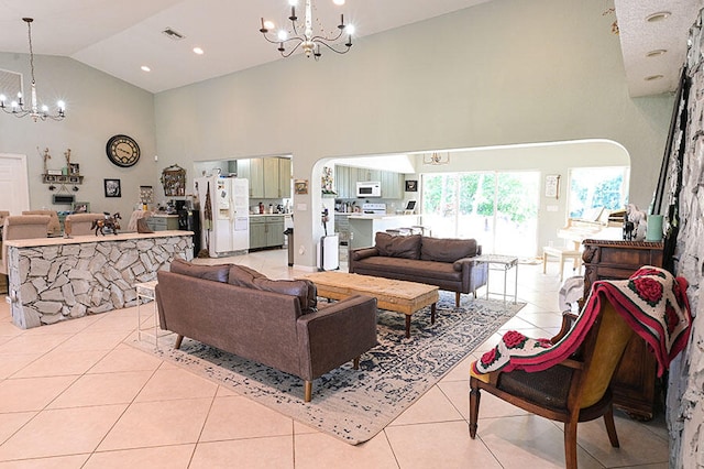 living room featuring a notable chandelier, high vaulted ceiling, and light tile patterned floors