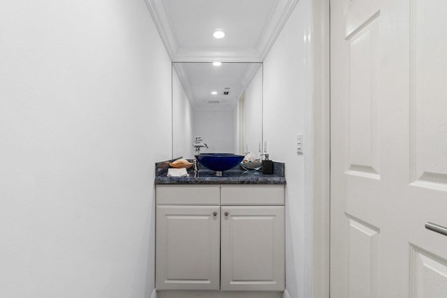 bathroom with vanity and ornamental molding