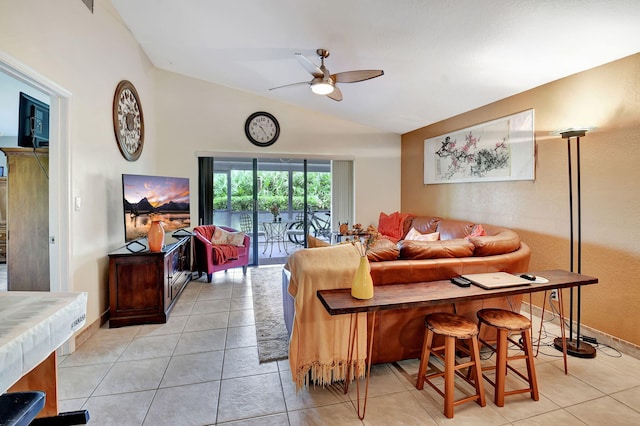 tiled living room featuring ceiling fan and lofted ceiling