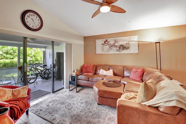 living room with ceiling fan, light tile patterned floors, and lofted ceiling