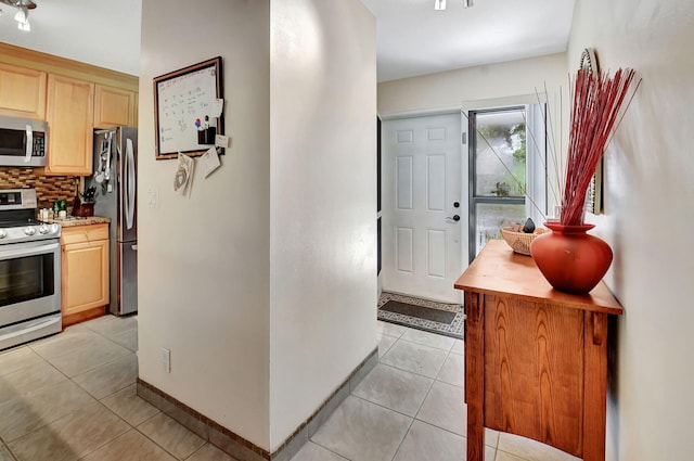 entryway with light tile patterned flooring