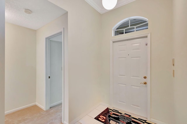 entryway featuring light colored carpet and a textured ceiling