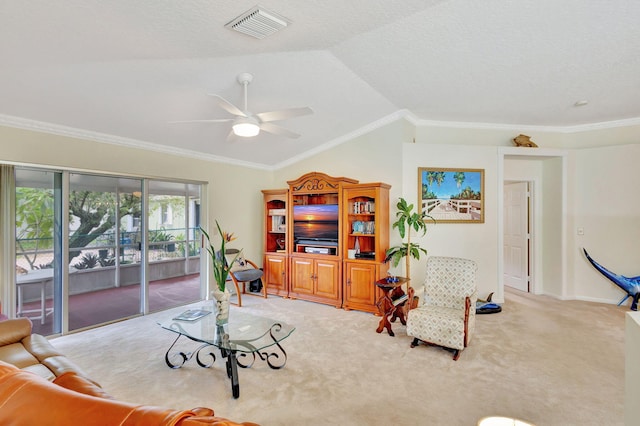 carpeted living room with ceiling fan, lofted ceiling, and crown molding