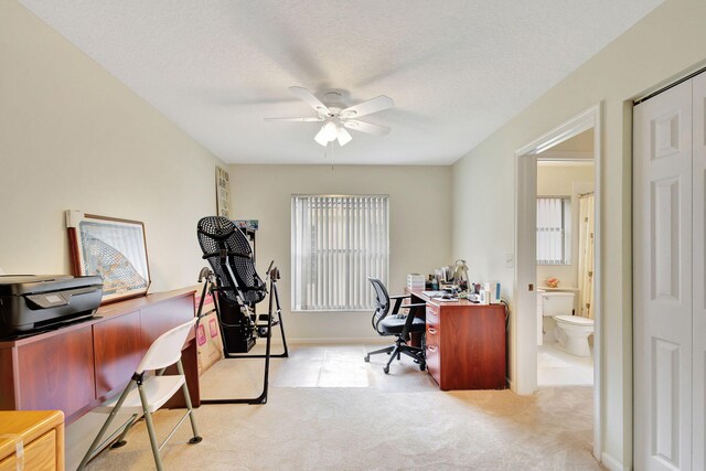 bedroom with ceiling fan, ensuite bath, light carpet, and vaulted ceiling