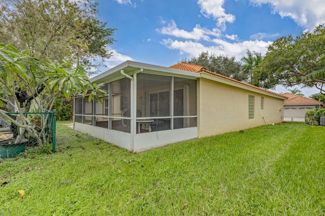 view of property exterior with a lawn and a sunroom