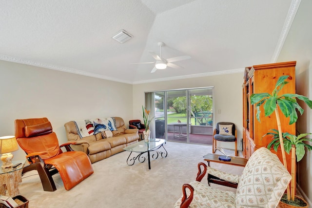 carpeted living room featuring a textured ceiling, vaulted ceiling, ceiling fan, and ornamental molding