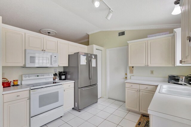 kitchen with kitchen peninsula, a textured ceiling, white dishwasher, white cabinetry, and lofted ceiling