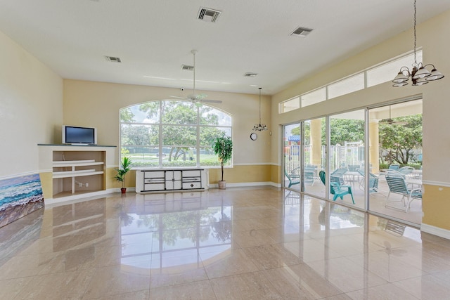 tiled living room with ceiling fan with notable chandelier