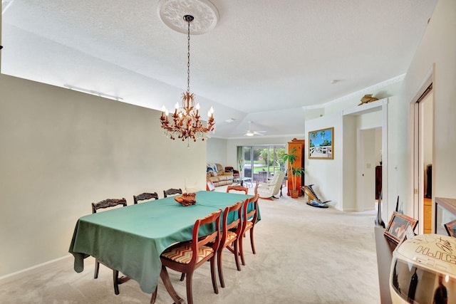 dining space with ceiling fan with notable chandelier, light colored carpet, and lofted ceiling