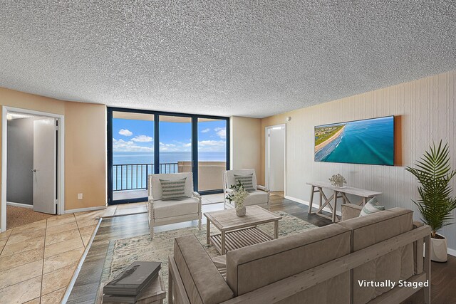 balcony featuring a water view and a view of the beach